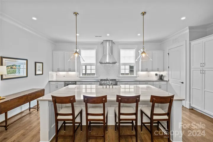 Huge kitchen island with designer pendants