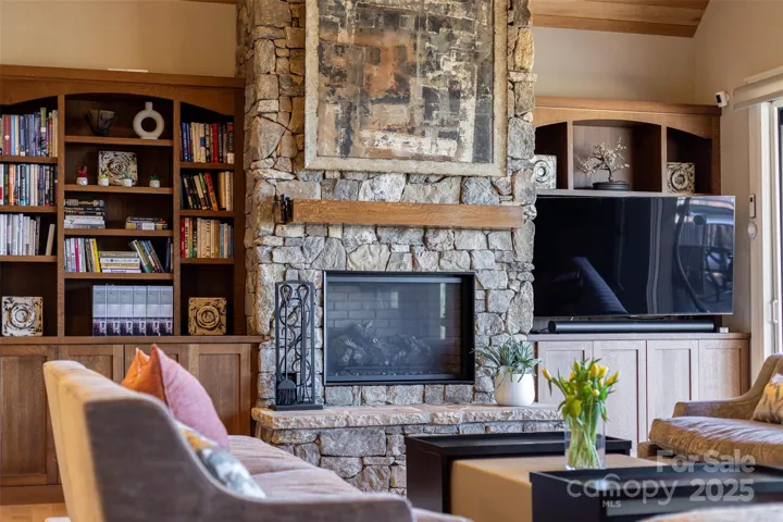 Beautiful stacked stone, gas log fireplace with custom-built quarter sawn oak mantel and cabinets and shelves in the great room.