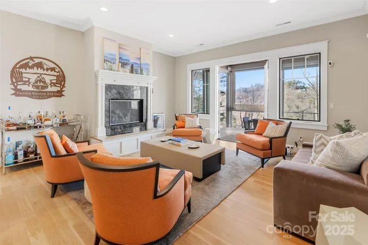 Terrace level family room has a gas fireplace and opens onto the covered lower deck.