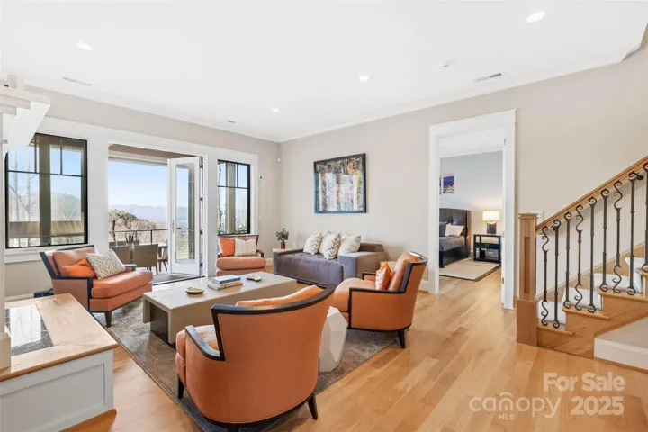 Terrace level family room with custom staircase with french doors that open onto the covered lower deck with expansive views.