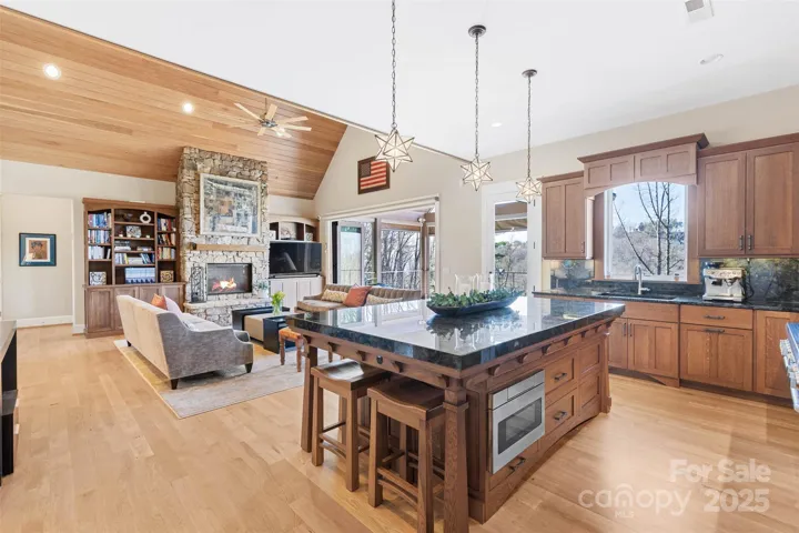 Large custom-built quarter sawn white oak island with custom stools for 4 and integrated drawers in the open kitchen.