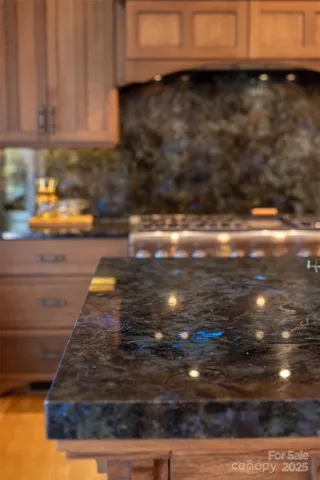 Solid Labradorite stone countertops and backsplash with iridescent pops of blues and greens.