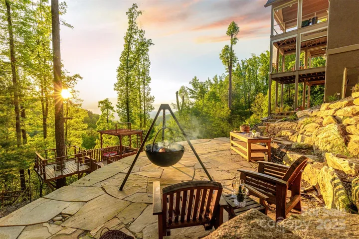 Count the stars while roasting marshmallows in the cauldron fire pit. Playhouse, multiple seating areas and raised garden beds round out features.