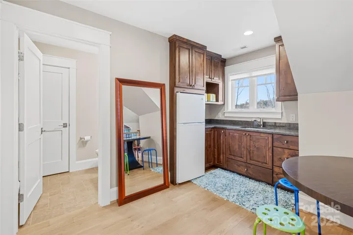 Guest suite over garage offers media area, bunkroom, kitchenette, full bathroom and walk-in closets.