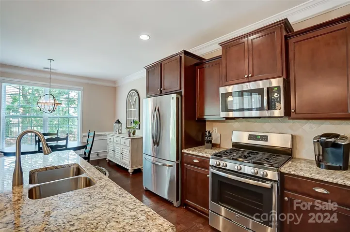 The kitchen you have been dreaming of w/ ss appliances, gas range, tons of countertop space, and island w/ seating, makes your meal prep a delight