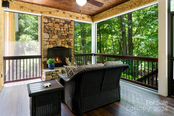 Screened porch with gas fireplace just off the kitchen and leading to a large deck.