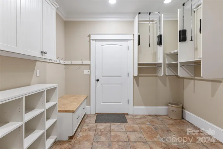 Mud room off attached garage has plenty of storage