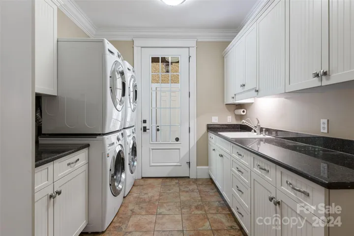 Spacious laundry room with 2 washers & dryers