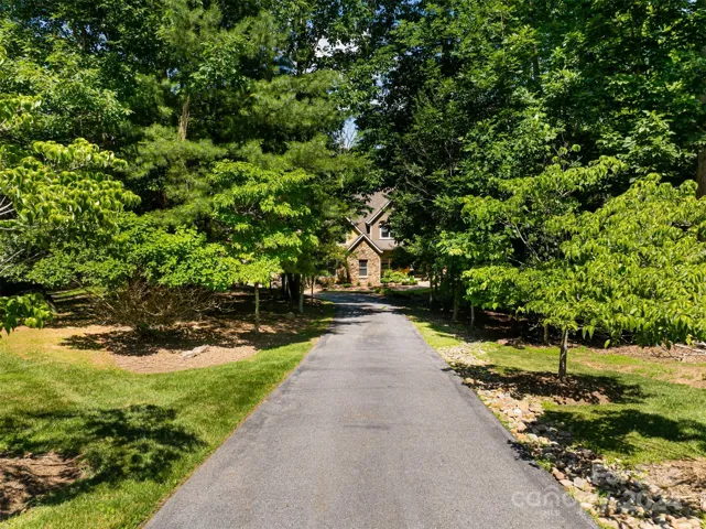 Set back from the road with an enchanting drive that creates privacy