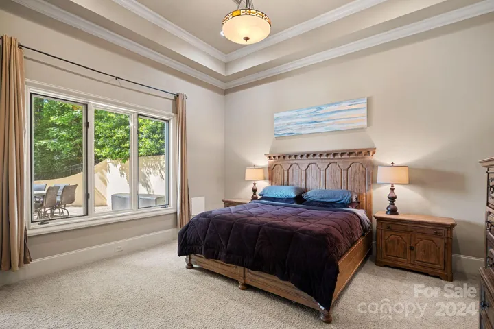 Lower level 2nd Primary Suite with lake view, gas fireplace, ensuite. Not pictured - ensuite connects to the home gym, which passes through to the recreation room.