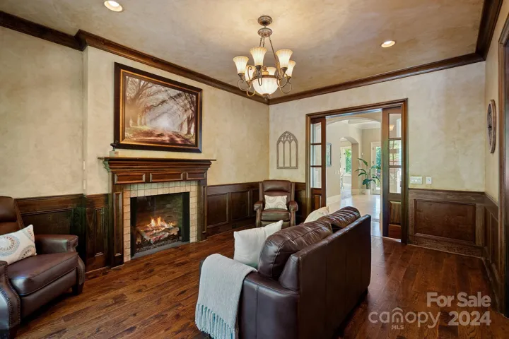 Enjoy socializing or unwinding in the inviting den/study equipped with gas fireplace for ambiance and pocket doors for privacy.