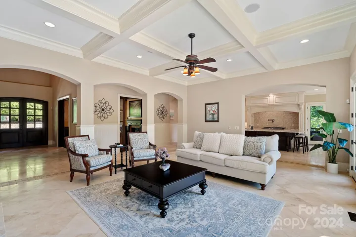Bright, open Great Room with gas fireplace, coffered ceiling, views to Lake Norman.