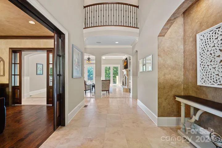 Large entry foyer flanked by the den/study with privacy pocket doors.
