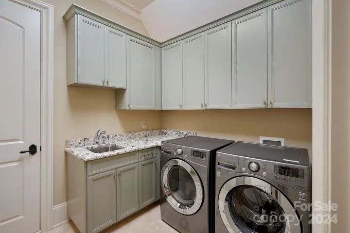 Upper Laundry room with walk-in attic access. Two HVAC's are access via this attic entrance.