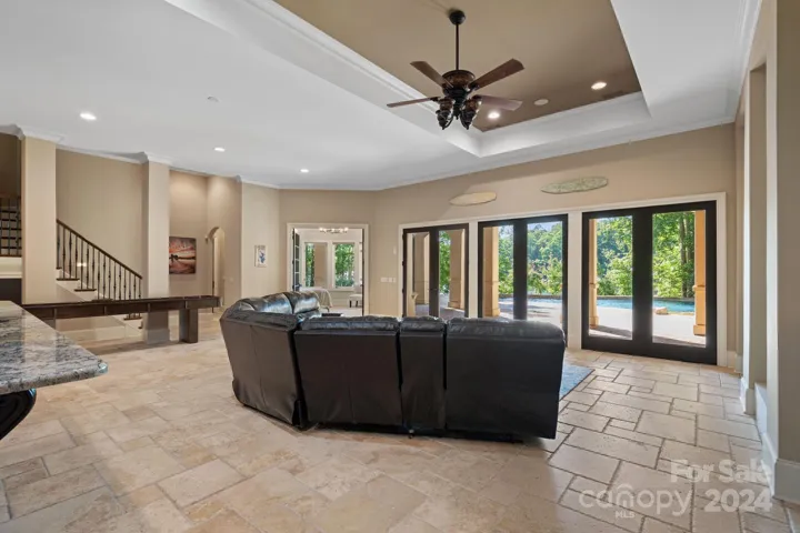 Lower level Recreation Room with gas fireplace, 2nd kitchen (microwave, refrigeration, ice maker, dishwashing drawer), Guest bedroom #4, hall full bathroom, home theater, wine cellar, and 2nd Primary Suite.