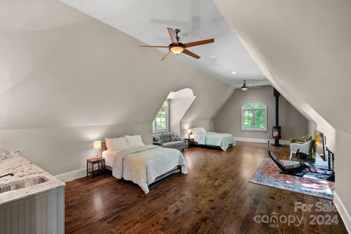 Expansive bonus room with wet bar and wood burning vented fireplace.