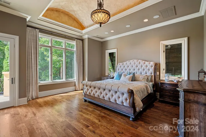 Primary Suite with lake views, gas fireplace, beautiful coved ceiling, and convenient dry bar.