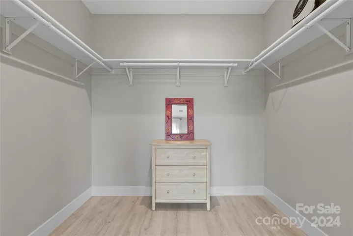 Primary bedroom walk in closet