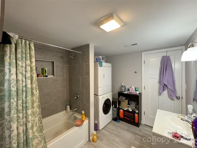 Basement full bathroom . Washer and dryer inside.
