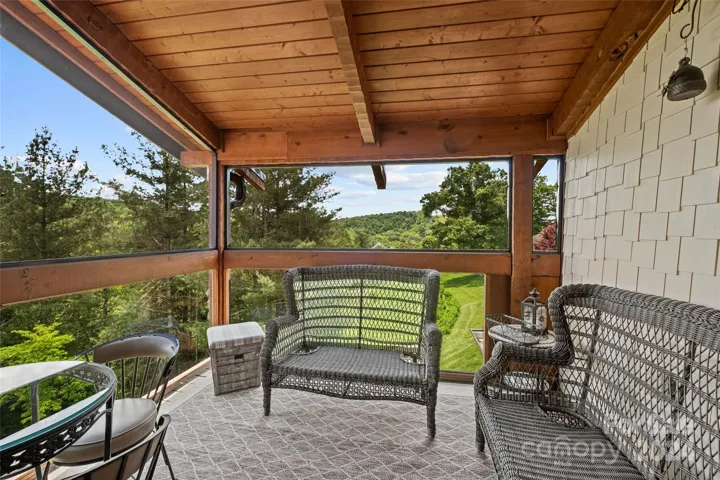 Upper level primary suite's private screened-in deck.