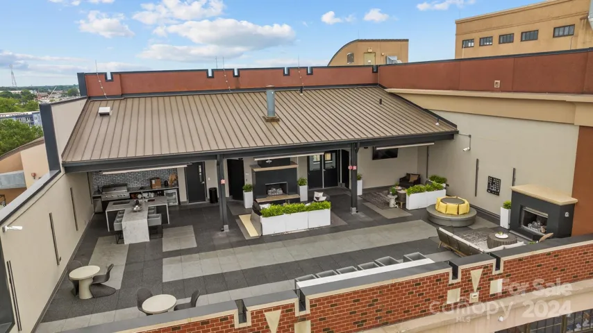 Rooftop Amenity Center with outdoor kitchen, fireplace and seating areas