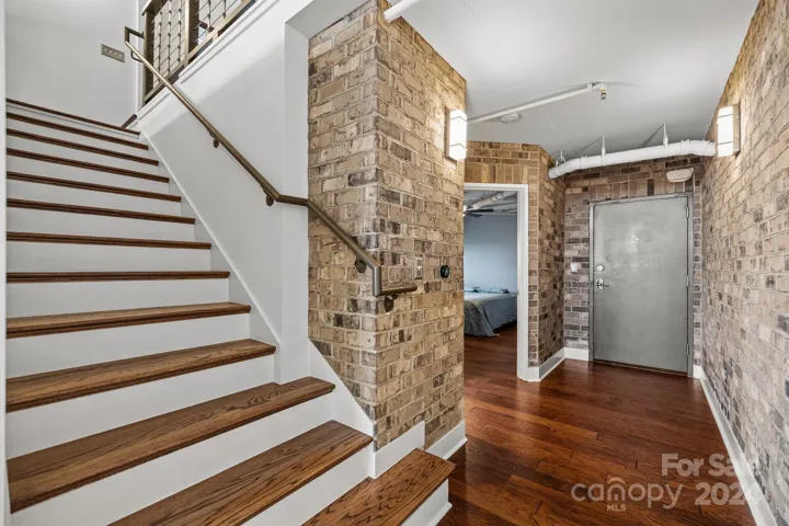 Main entry with brick accent walls and beautiful oak staircase