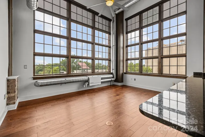 End unit condo with floor to ceiling windows and city view