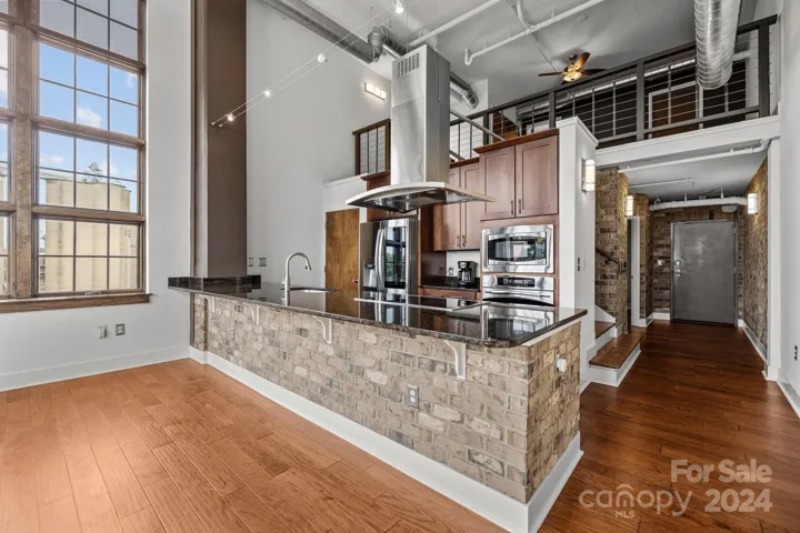 Open, modern living space with gourmet kitchen