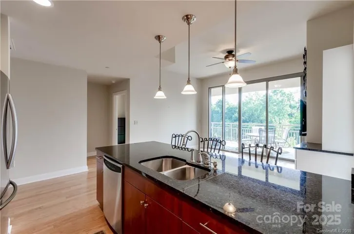 Kitchen looking into Living Room and Balcony.