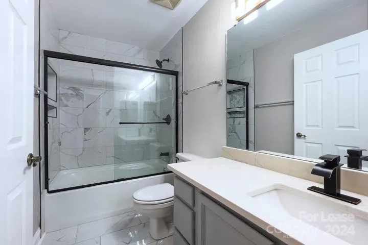 Updated 2nd bath with quartz countertops and tile surround