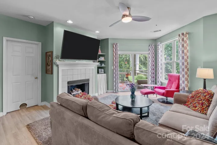 Sunny living room with gas log fireplace for chillier weather.