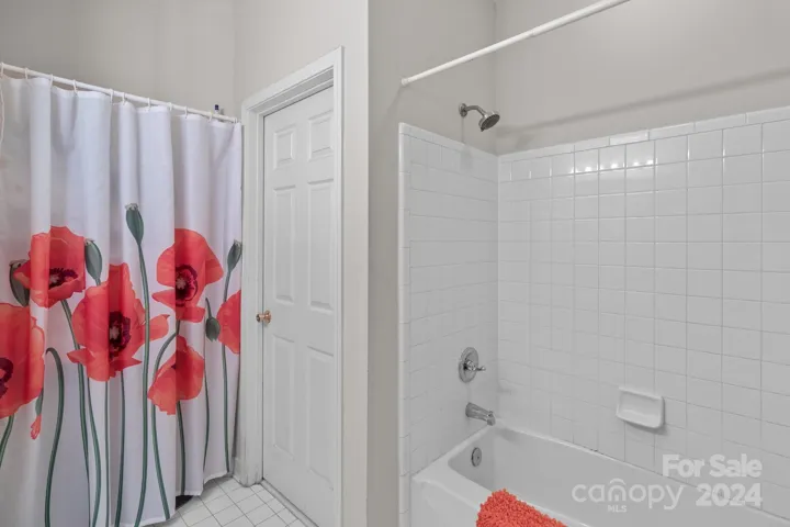 Hall bath with tub/shower combination.