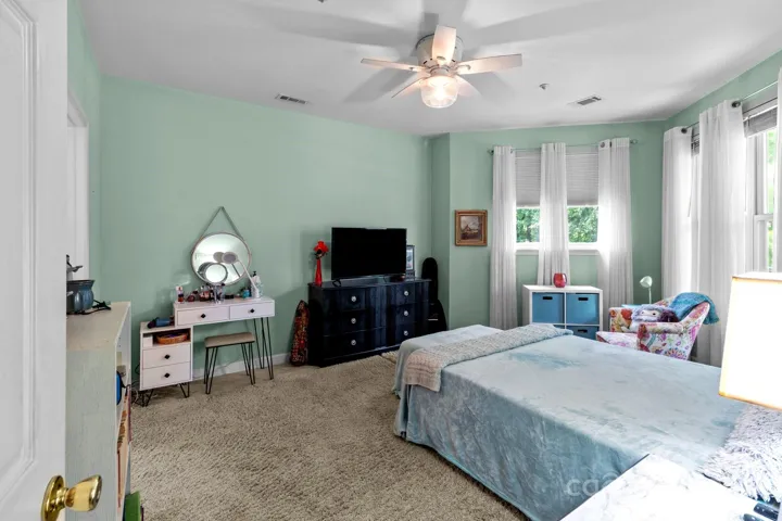 Very generous primary bedroom with windows looking out at the lake.