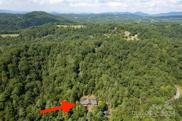 Northwest Aerial view of the home and surrounding mountains