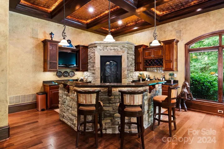 Game room includes wetbar with industrial size refrigerator