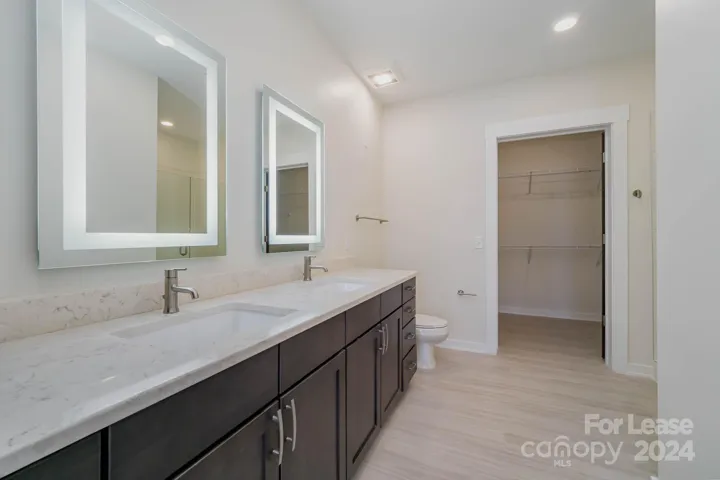 Primary bedroom has gorgeous ensuite bathroom with lots of light and counterspace!