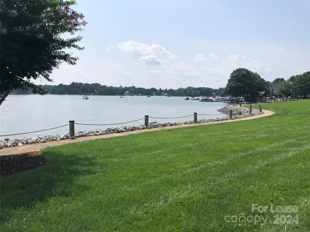 Lakeside walking trail with lush lawn