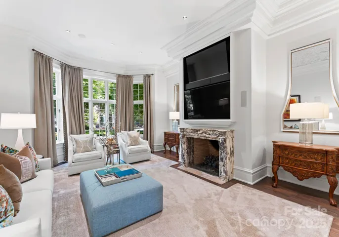 Hearth Room offers spacious and comfortable room with rich accents, fireplace, and custom furniture.