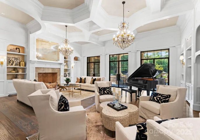 Library with dual Schonbeck custom crystal chandeliers. Custom Furniture by Massoud and CR Laine, and  Grand Piano.