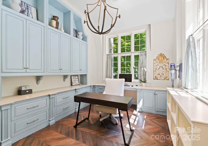 Secondary home office custom cabinetry and chevron floors.