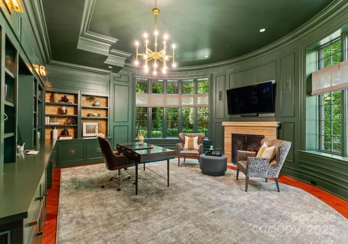 Executive Office with fireplace, sitting area with custom CR Laine furniture, 90” windows with 180 degree view of pond & terrace. Oversized closet and file storage system.