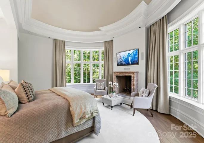 Primary bedroom with 90” windows and 180 degree views. Vaulted ceiling with intricate crafted molding, new drapery, and coffee and beverage station.