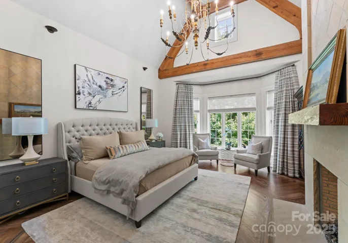 Bed and breakfast style Guest retreat with vaulted ceiling, exposed beams, and fireplace.
