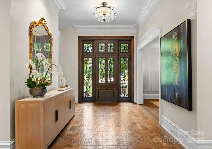Grand entrance with custom hand-hewn Versailles parquet floors.
