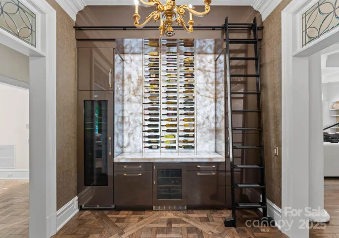 Custom butlers pantry with transitional wine closet and rack system with custom backlight.Cristallo quartzite countertops
