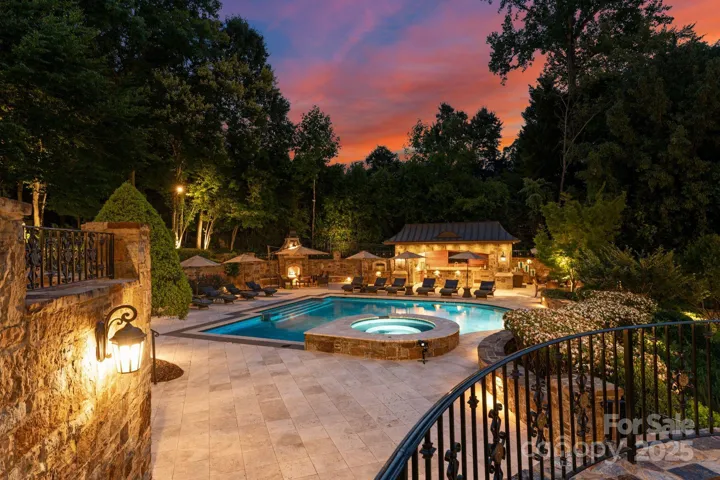 Back terraces overlook the saltwater pool and hot tub. Travertine patio decking with hand chipped stone hardscaping, and lush manicured landscaping.