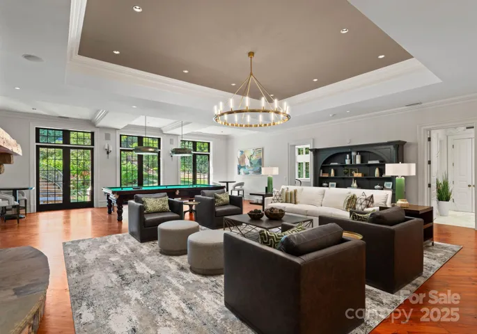 Living area, custom furniture by CR Laine and Massoud. Hudson Valley XL chandelier, 4 visual comfort sconces8’ French doors to walkout terrace.