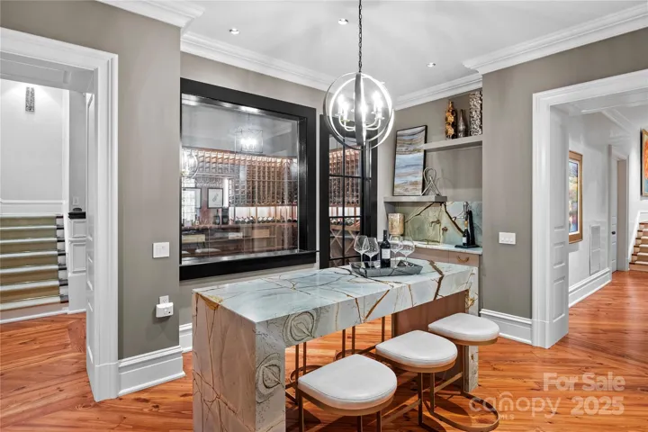 Blue Roma Quartzite tasting table and wet bar with hammer copper sink and wall mounted faucet.