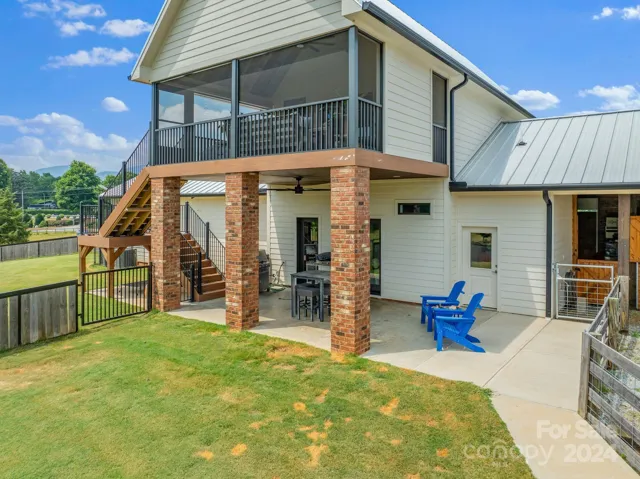 Back elevation with porch, patio, and access to the stable area. Small door to the right is a tack room with heat and air.
