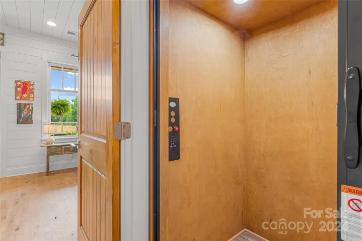 Hydraulic elevator to the upper level fits three people easily.